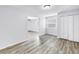 Bright bedroom with wood look flooring, white trim, and closets for ample storage at 15604 Deerglen Dr, Tampa, FL 33624