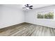 Bedroom with wood floors and a window with blinds at 15604 Deerglen Dr, Tampa, FL 33624