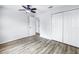 Clean bedroom with wood-look flooring, white walls, and a large closet at 15604 Deerglen Dr, Tampa, FL 33624