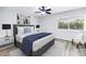 Comfortable bedroom featuring a queen bed, soft rug, and a bright window at 15604 Deerglen Dr, Tampa, FL 33624