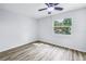 Bright bedroom with wood floors and a window overlooking lush greenery at 15604 Deerglen Dr, Tampa, FL 33624