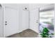 Bright entryway with tile floors and a large plant by a decorative glass window at 15604 Deerglen Dr, Tampa, FL 33624