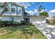 Charming two-story home with a blue exterior, well-manicured lawn, and a two-car garage at 15604 Deerglen Dr, Tampa, FL 33624