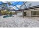 View of the pool from the home featuring a screened-in pool and stone paver deck at 15604 Deerglen Dr, Tampa, FL 33624