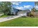 Charming two-story home with blue accents, lush landscaping, and a spacious driveway and front yard at 15604 Deerglen Dr, Tampa, FL 33624