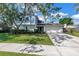 Charming two-story home with blue accents, lush landscaping, and a spacious driveway and front yard at 15604 Deerglen Dr, Tampa, FL 33624
