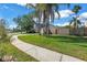 Home exterior with manicured lawn and mature trees at 15604 Deerglen Dr, Tampa, FL 33624