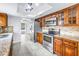Well-lit kitchen with stainless steel appliances, granite countertops, and hardwood cabinets at 15604 Deerglen Dr, Tampa, FL 33624
