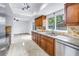 Kitchen featuring wood cabinetry, granite countertops, and stainless steel appliances at 15604 Deerglen Dr, Tampa, FL 33624