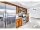 Kitchen with stainless steel appliances, wooden cabinets, and tile backsplash at 15604 Deerglen Dr, Tampa, FL 33624