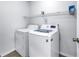 Laundry room featuring a white washer and dryer with wire shelving at 15604 Deerglen Dr, Tampa, FL 33624