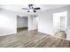 Bright living room boasts neutral paint, modern ceiling fan, and durable wood-look flooring at 15604 Deerglen Dr, Tampa, FL 33624