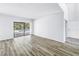 Spacious living room with wood-look flooring and sliding glass doors leading to the outdoor area at 15604 Deerglen Dr, Tampa, FL 33624
