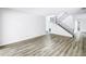 Bright living room with hardwood flooring and stairs to the upper level at 15604 Deerglen Dr, Tampa, FL 33624