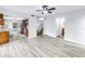 Open-concept floor plan featuring wood-look flooring, connecting the kitchen, living, and dining areas at 15604 Deerglen Dr, Tampa, FL 33624