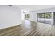 Bright living room with hardwood flooring and sliding glass doors to the outdoor patio at 15604 Deerglen Dr, Tampa, FL 33624