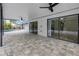The covered porch features stone pavers, ceiling fans, and access to the main house at 15604 Deerglen Dr, Tampa, FL 33624