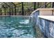 Screened in pool with tile trim featuring a water feature to add style and serenity to the space at 15604 Deerglen Dr, Tampa, FL 33624