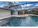 Beautiful in-ground pool with spa, screened enclosure, patio, and lush landscaping at 15604 Deerglen Dr, Tampa, FL 33624