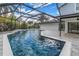 Tranquil in-ground screened pool with waterfall feature and pavers perfect for entertaining at 15604 Deerglen Dr, Tampa, FL 33624