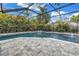 Screened in-ground pool with brick pavers, lush landscaping and fountain feature at 15604 Deerglen Dr, Tampa, FL 33624