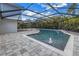 Screened in pool area includes an in-ground pool with water feature and a paved patio at 15604 Deerglen Dr, Tampa, FL 33624