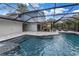 Pool area featuring a screened-in enclosure, dining area, and comfortable patio seating at 15604 Deerglen Dr, Tampa, FL 33624