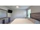 Neutral bedroom with a ceiling fan, TV, dresser, carpet, and a window with blinds at 17015 Coral Key Dr, Nokomis, FL 34275