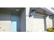 A welcoming entrance featuring a blue door, detailed trim, and a carriage light at 17015 Coral Key Dr, Nokomis, FL 34275