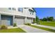 Charming two-story home with a manicured lawn, inviting curb appeal and attached two-car garage at 17015 Coral Key Dr, Nokomis, FL 34275