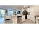 Bright kitchen with a large island, stainless steel appliances, and views to the living room at 17015 Coral Key Dr, Nokomis, FL 34275