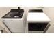 A laundry room features a Whirlpool washer and dryer with front-load designs with glass doors and electronic controls at 17015 Coral Key Dr, Nokomis, FL 34275