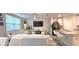 An open-concept living room features a flat screen TV, white couches, glass tables, and an eat-in kitchen at 17015 Coral Key Dr, Nokomis, FL 34275