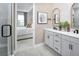 Elegant bathroom showcasing double vanities, modern fixtures, and an open view to a bedroom for added space at 17420 Moonflower Dr # 201, Venice, FL 34293