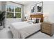 Cozy bedroom with plush headboard, decorative pillows, and bedside tables for a relaxing and inviting space at 17420 Moonflower Dr # 201, Venice, FL 34293