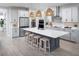 Spacious kitchen featuring a large island, stainless appliances, pendant lights and ample counter space at 17420 Moonflower Dr # 201, Venice, FL 34293