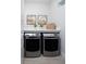 Modern laundry room with side by side washer and dryer with a white countertop at 17420 Moonflower Dr # 201, Venice, FL 34293
