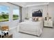 Bright bedroom with a large bed, white linens, river views, and stylish decor at 17420 Moonflower Dr # 203, Venice, FL 34293