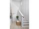 Inviting entryway with staircase, wooden bench, accent wall and natural light at 17420 Moonflower Dr # 203, Venice, FL 34293