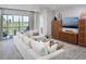Bright living room with balcony access, comfortable sectional sofa, and stylish furnishings at 17420 Moonflower Dr # 203, Venice, FL 34293