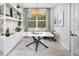 Bright study with custom built-ins, modern light fixture, and large window at 17420 Moonflower Dr # 203, Venice, FL 34293