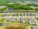 An aerial view showcases houses along a canal with lush green trees and well-maintained lawns at 17618 Cortes Creek Blvd, Spring Hill, FL 34610