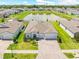 Expansive aerial view of home showcasing landscaping, pond, and neighboring houses at 17618 Cortes Creek Blvd, Spring Hill, FL 34610