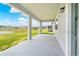 This covered back porch offers a great view of the pond and backyard space at 17618 Cortes Creek Blvd, Spring Hill, FL 34610