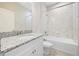 Bright bathroom featuring vanity with granite counters, shower with tub combination and tile surround at 17618 Cortes Creek Blvd, Spring Hill, FL 34610