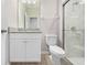 A bathroom with granite countertop vanity, toilet, and glass-enclosed tiled shower at 17618 Cortes Creek Blvd, Spring Hill, FL 34610