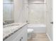 Bright bathroom with granite countertop, single sink, and a shower-over-tub with tiled walls at 17618 Cortes Creek Blvd, Spring Hill, FL 34610