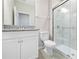 Bathroom with granite countertop vanity, toilet, and a glass-enclosed tiled shower at 17618 Cortes Creek Blvd, Spring Hill, FL 34610