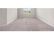A spacious bedroom has neutral walls, carpet, and a window at 17618 Cortes Creek Blvd, Spring Hill, FL 34610