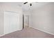 Bright bedroom featuring carpeted floors, a closet, and natural light coming from a window at 17618 Cortes Creek Blvd, Spring Hill, FL 34610